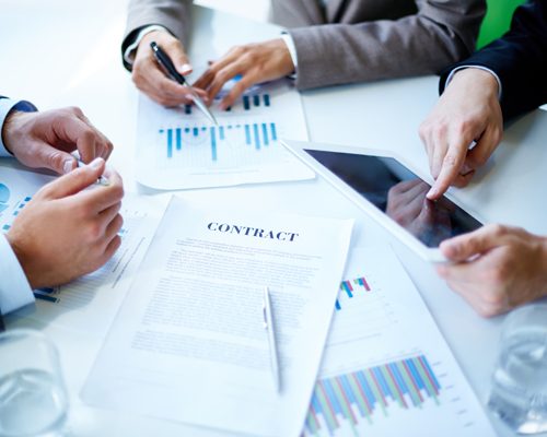 Image of business documents, touchpad, pen and glasses on workplace at meeting